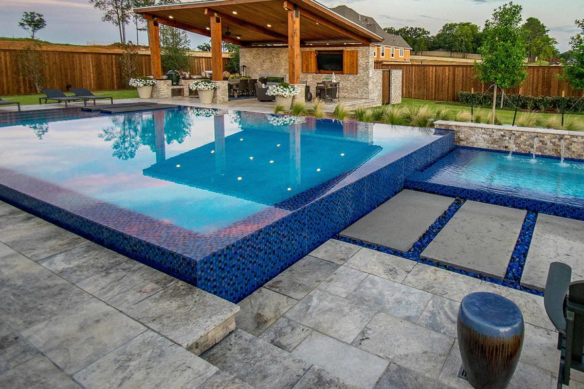 photo of a backyard pool design in PebbleTec PebbleBrilliance Aqua Falls Pool Finish with lightstreams tile features