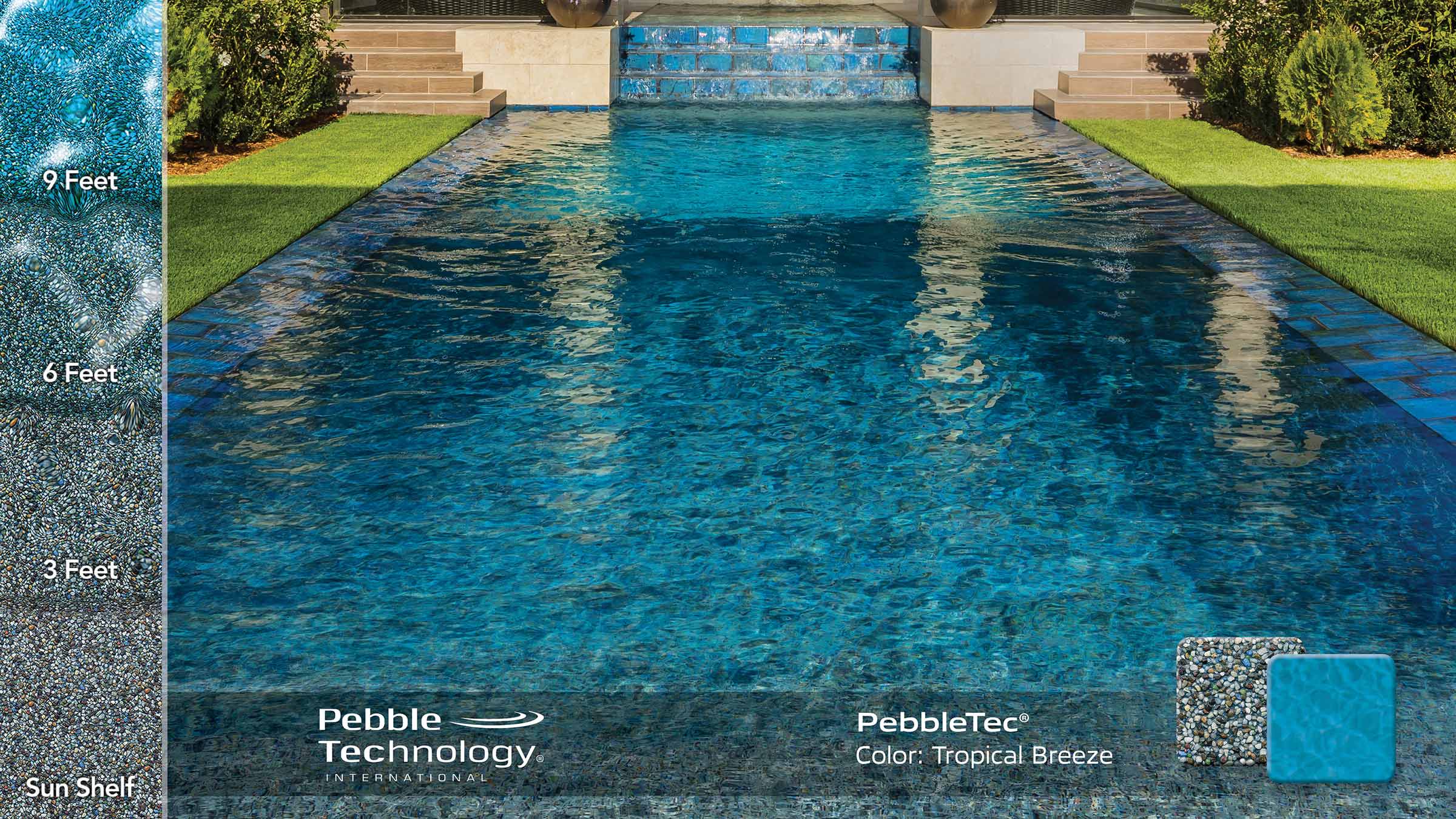 photo of backyard pool design with waterfall feature in PebbleTec Tropical Breeze Pool Finish: A predominantly grey finish intermixed with blue, green and burnt orange pebbles and enhanced with Shimmering Sea.