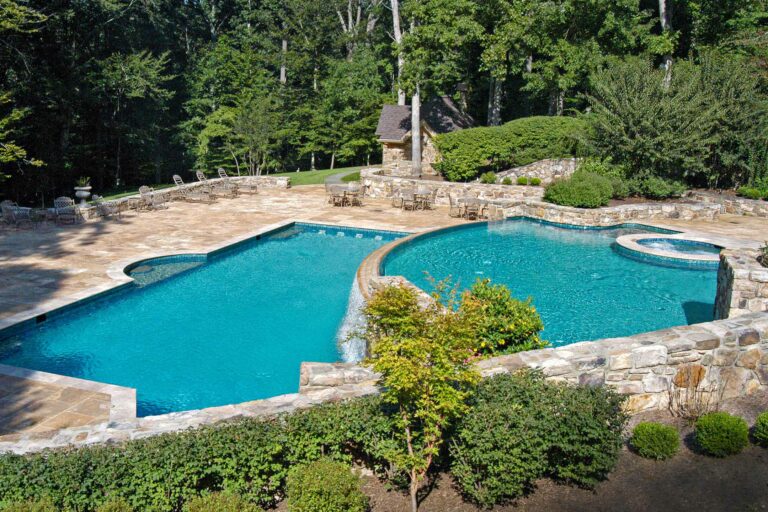 photo of a tiered pool backyard design with a waterfall feature in PebbleTec Creme De Menthe Pool Finish medium blue water color