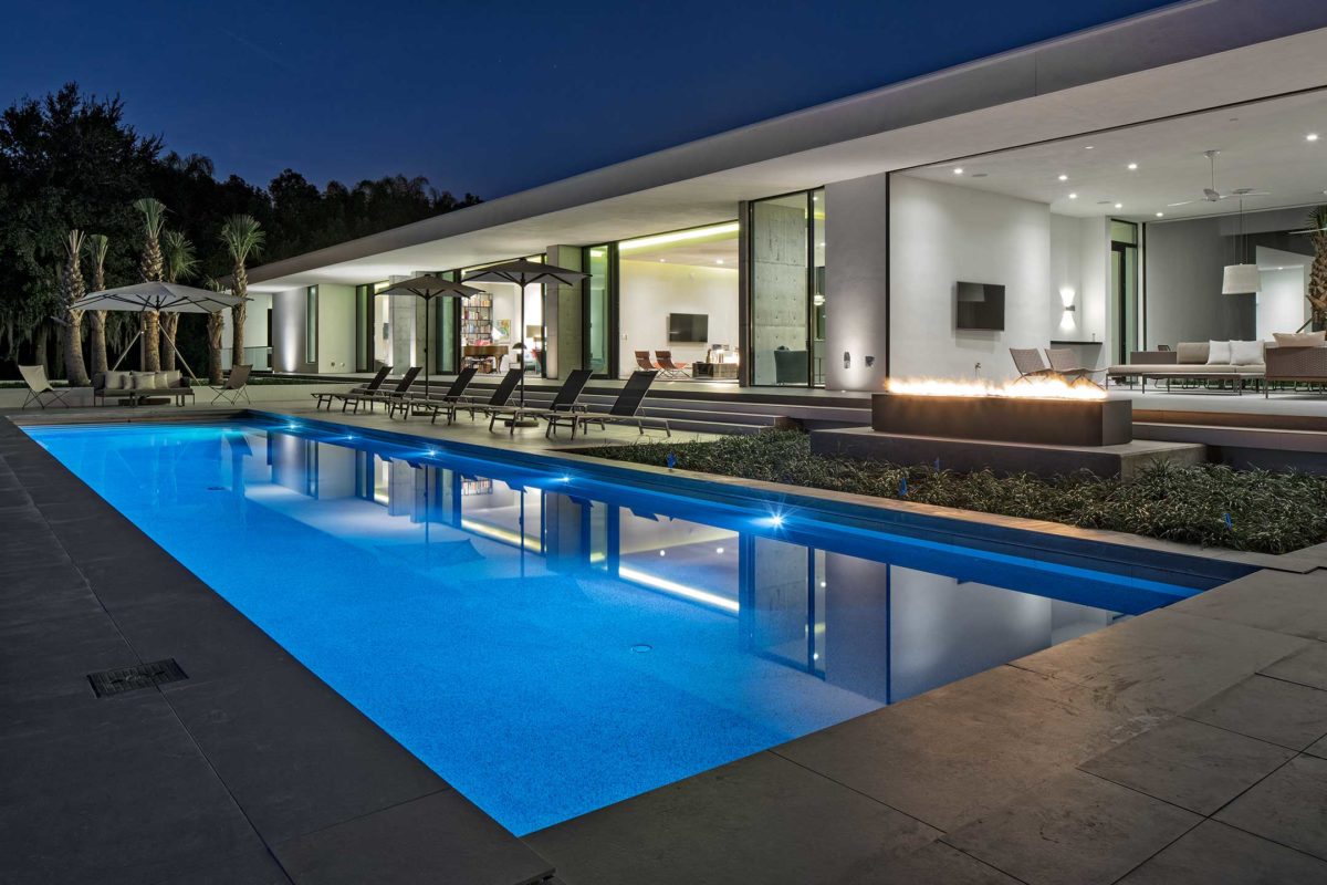 photo of a lap pool in PebbleTec Moonlight Pool Finish medium blue water color in a backyard dream home