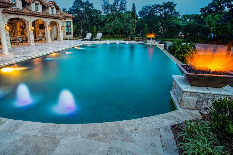 photo of a backyard pool design in PebbleTec Jade Pool Finish medium blue water color with fire bowls and water features