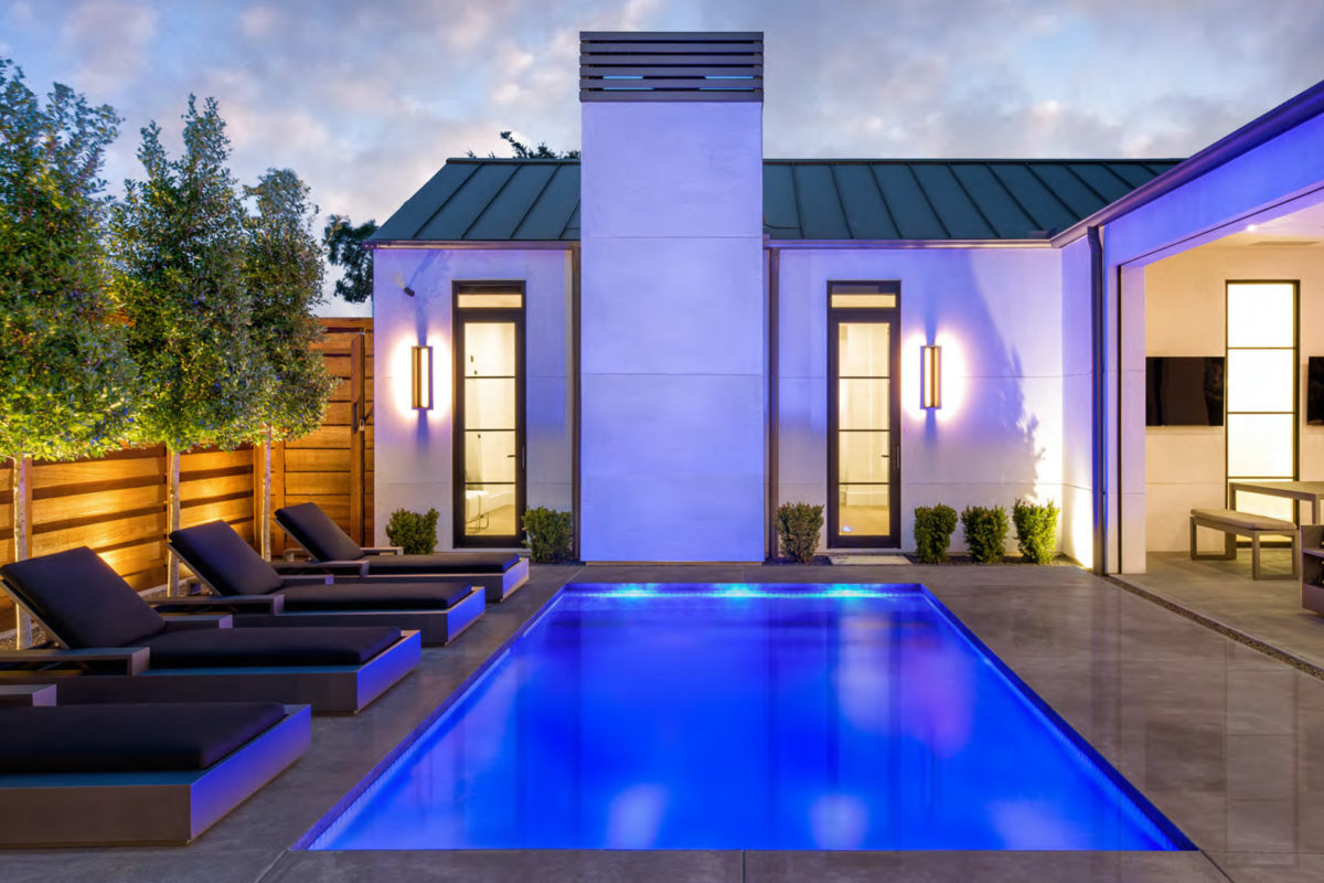 photo of a backyard pool design in the evening of PebbleTec PebbleBrilliance Clearwater Pool Finish submitted for World's Greatest Pools 2019