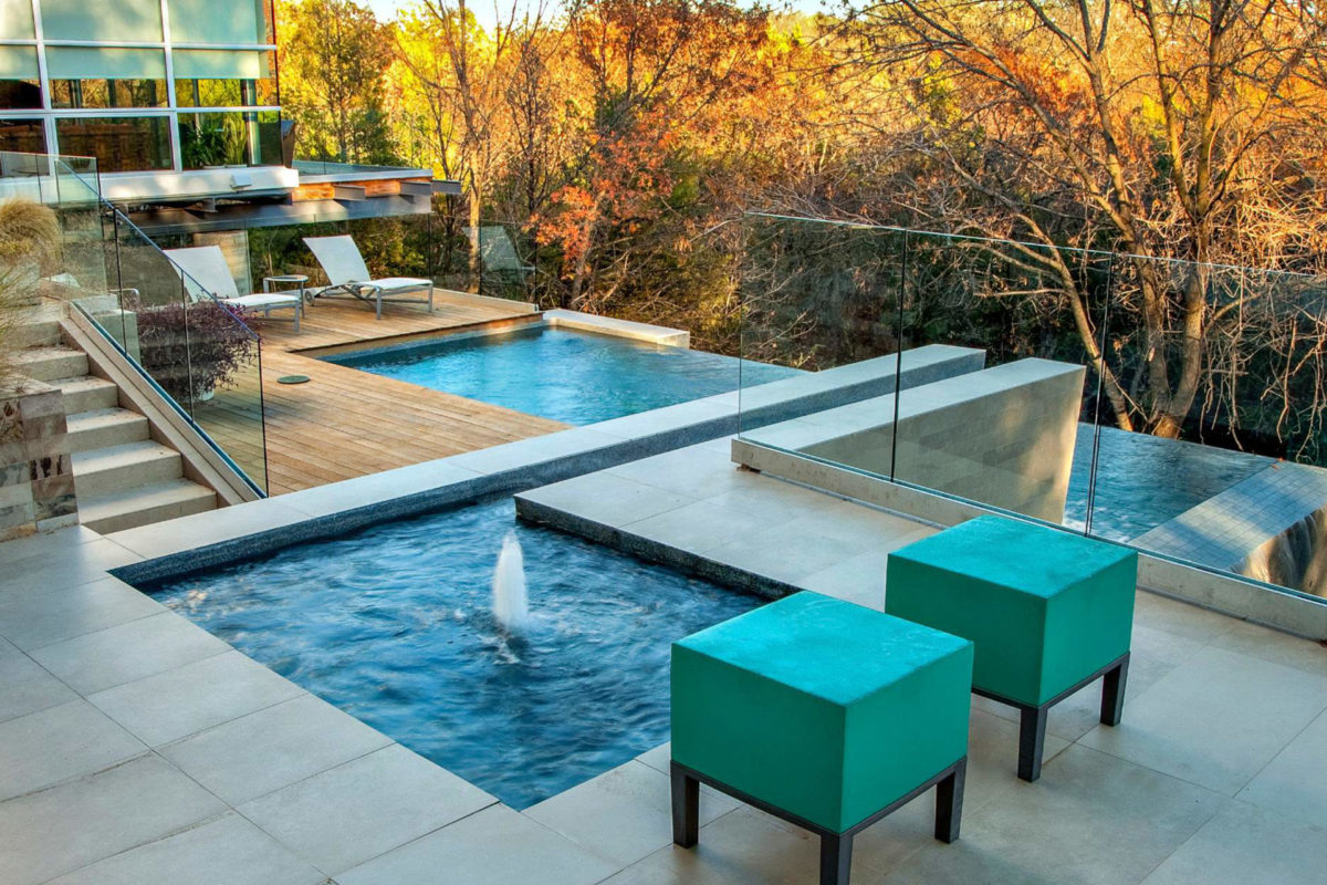 photo of a backyard pool and jacuzzi design in PebbleTec Tahoe Blue Pool Finish during fall season