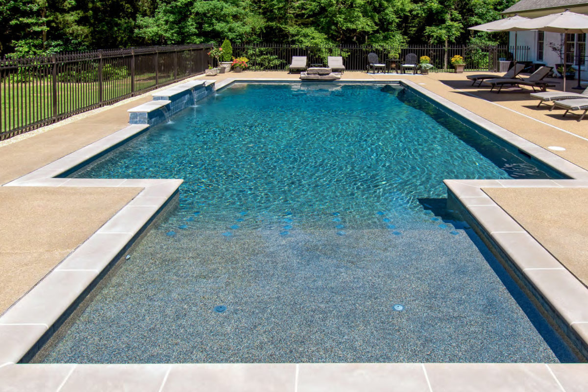 photo of a backyard pool design in PebbleTec Tahoe Blue Pool Finish medium blue water color