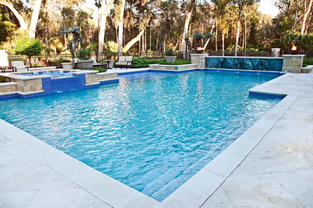 photo of backyard pool and jacuzzi design in PebbleBreeze Fresh Water Pool Finish with waterfall features and Lightstreams tile
